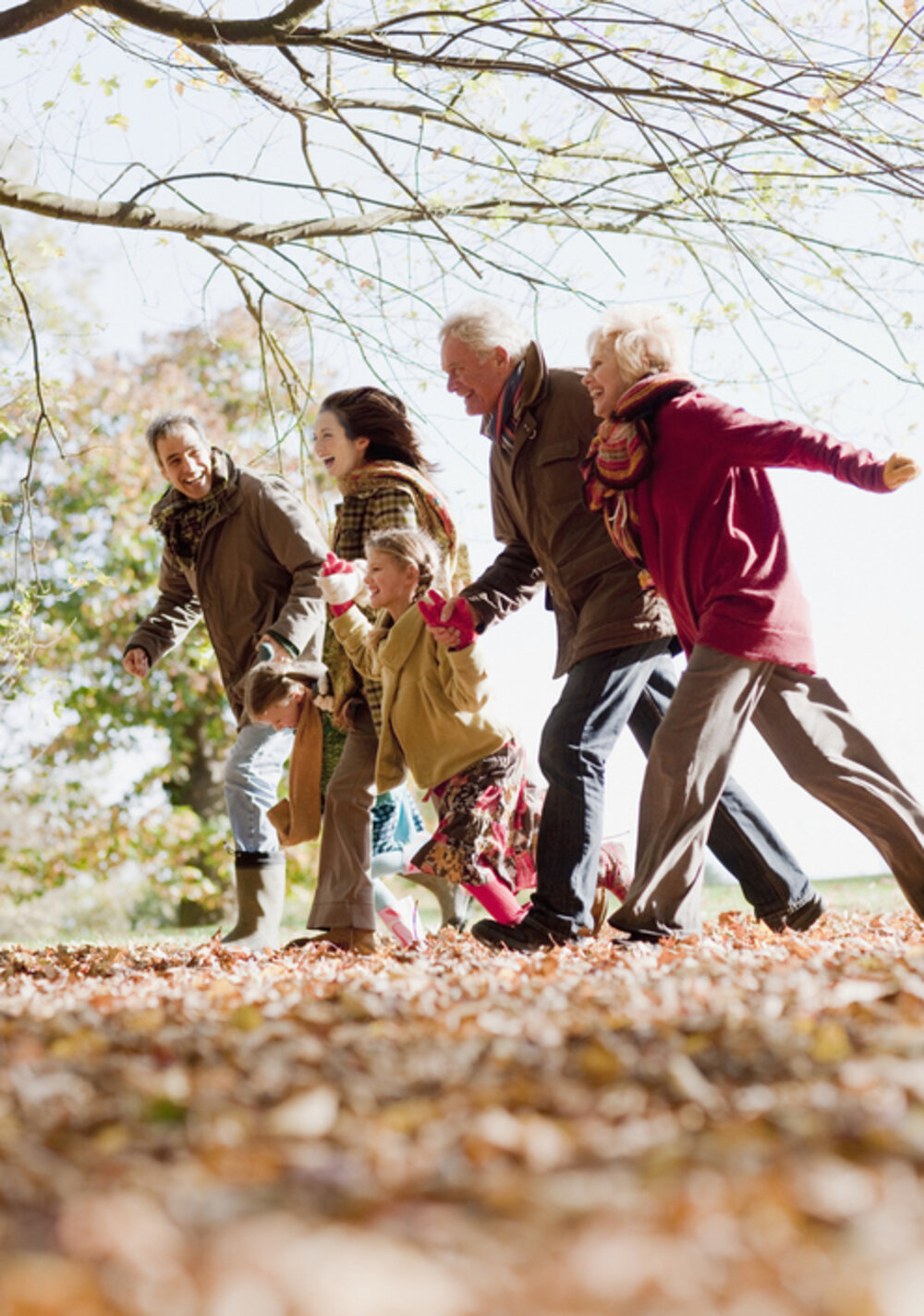 Three generations of a family walking together outdoors